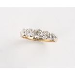 A yellow gold diamond five stone ring, the round brilliant cut diamonds weighing an estimated