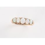An early 20th century unmarked yellow gold opal five stone ring, size P.