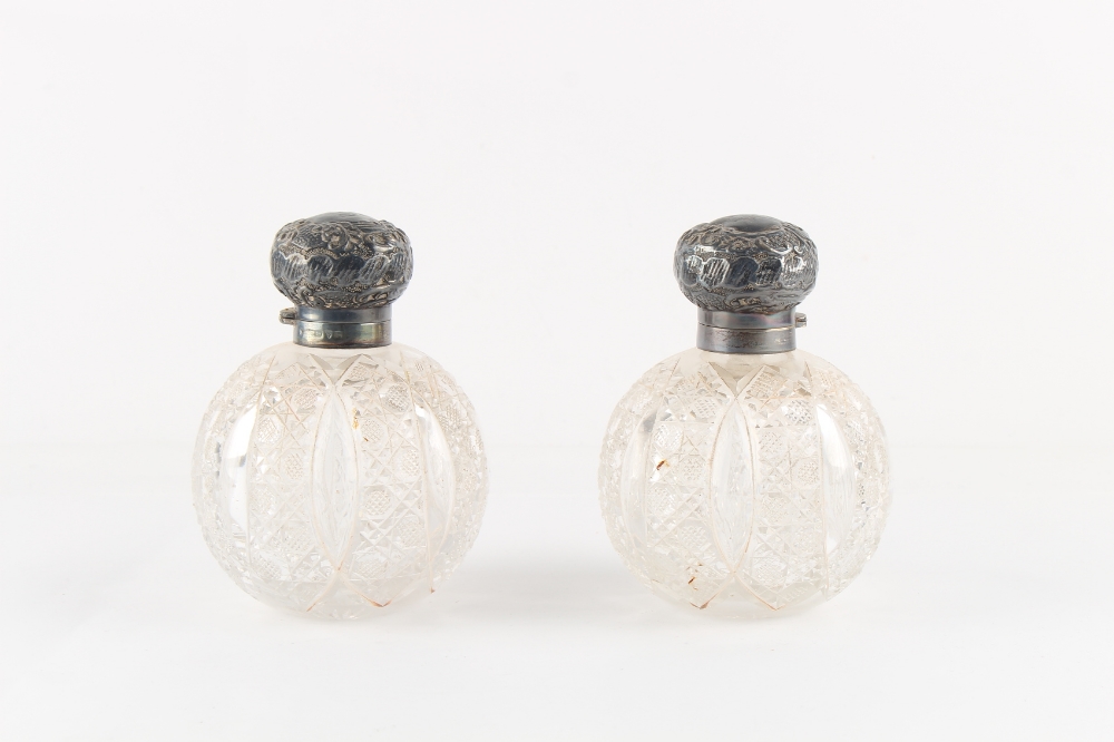 Property of a deceased estate - a pair of Victorian silver topped cut glass globe scent bottles with