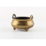A Chinese bronze two-handled tripod censer of bombe form, 18th century, Xuande 6-character mark to