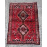 Property of a deceased estate - a modern Persian woollen hand knotted rug, with red ground, 67 by
