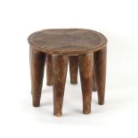 Property of a lady - an African Ashanti tribal carved wooden eight legged stool, with incised