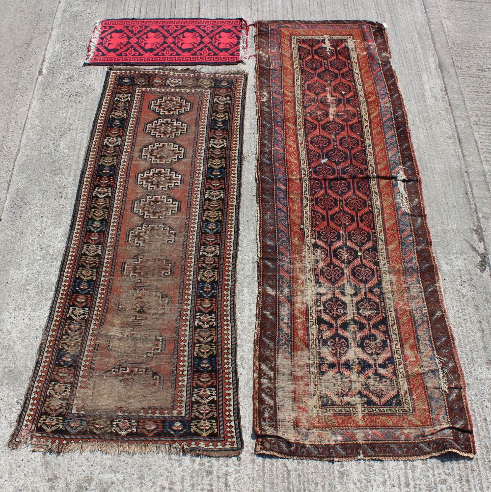 Property of a gentleman - an early 20th century Caucasian Kazak long rug, worn, 114 by 41ins. (290