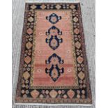 Property of a lady - a Caucasian rug with faded red ground & four small figures to one end, 90 by