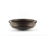 Property of a lady - an Indian bronze urli or temple bowl, 17.15ins. (43.5cms.) across handles.