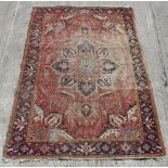 Property of a gentleman - an early 20th century Heriz carpet, mothed & worn, 132 by 88ins. (335 by