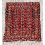 Property of a gentleman - a Turkoman rug, with three rows of guls, 49 by 42ins. (125 by 107cms.).