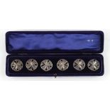 The Henry & Tricia Byrom Collection - an Edwardian cased set of six silver buttons, of pierced