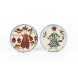 Two Turkish Ottoman Kutahya pottery small dishes, each painted with a standing figure, on a short