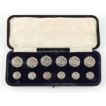 The Henry & Tricia Byrom Collection - an Edwardian cased set of twelve silver buttons, of two sizes,