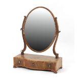 Property of a lady - a George III mahogany oval swing-frame toilet mirror with rosewood
