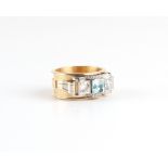 A modern heavy unmarked yellow & white gold zircon & diamond ring, the two principal round brilliant