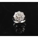 An 18ct white gold diamond cluster ring, with nine round brilliant cut diamonds, the estimated total