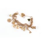 Property of a lady - a 9ct gold charm bracelet with heart shaped clasp, five of the ten charms