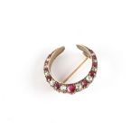 Property of a lady - an early 20th century unmarked yellow gold ruby & diamond crescent brooch,