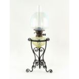 An Arts & Crafts wrought iron & vaseline glass oil lamp, possibly by John Walsh Walsh, Birmingham,