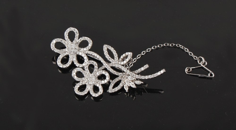 Property of a deceased estate - an 18ct white gold double flowerhead spray brooch, with marquise cut