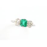 Property of a gentleman - an unmarked platinum emerald & diamond three stone ring, the rectangular