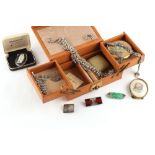 Property of a lady - a brown leather jewellery box containing a small quantity of costume jewellery,