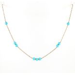 A 9ct yellow gold & turquoise bead necklace, 15ins. (38cms.) long.