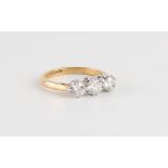 An 18ct yellow gold & platinum diamond three stone ring, the three round brilliant cut diamonds