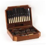 Property of a lady - an oak canteen containing silver plated cutlery.