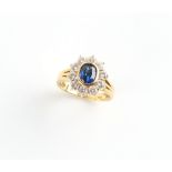 Property of a lady - an 18ct yellow gold sapphire & diamond oval cluster ring, the oval cushion cut