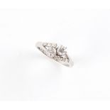 A 14ct white gold diamond crossover ring, with diamond shoulders, the two larger round brilliant cut