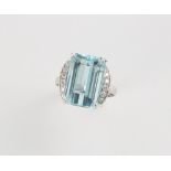 An 18ct white gold aquamarine & diamond ring, the rectangular step cut aquamarine weighing