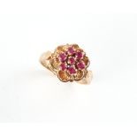 Property of a gentleman - an 18ct yellow gold ruby cluster ring, approximately 5.2 grams, size N.