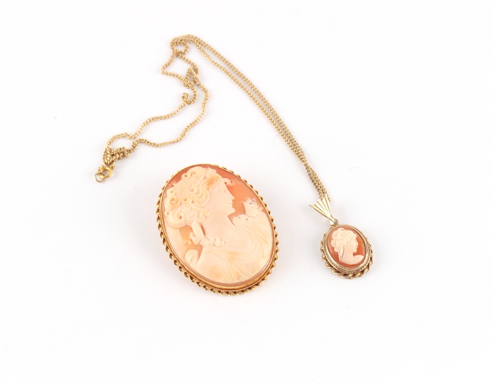 Property of a deceased estate - a 9ct gold mounted shell cameo brooch, 49mm long; together with a