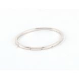 Property of a lady - an 18ct white gold hinged bangle set with five small diamonds, approximately