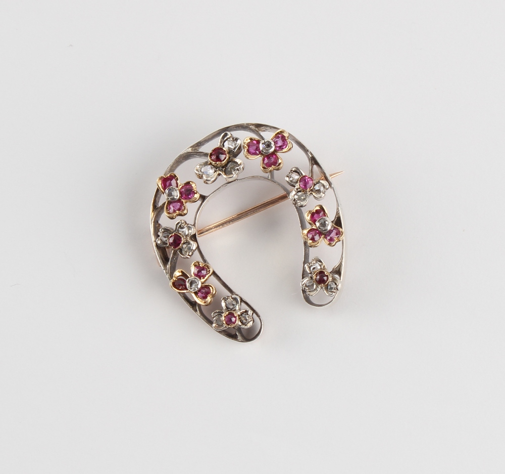 A Victorian unmarked rose gold ruby & diamond horseshoe brooch, 30mm long. - Image 2 of 3