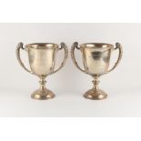 Property of a gentleman - a pair of early 20th century silver two handled trophy cups, with engraved