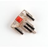 An Art Deco style yellow gold diamond coral & black onyx brooch, 33 by 36mm.