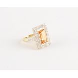An Art Deco style yellow gold topaz & diamond ring, the rectangular cut topaz weighing approximately