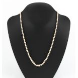 Property of a lady - a cultured pearl graduated single strand necklace, the largest pearl