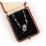 A diamond floral necklace, with diamond spacers, 17ins. (43cms.) long, in fitted box.