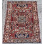 Property of a lady - an Afghan Kazak design hand knotted wool rug, with red ground, 88 by 63ins. (