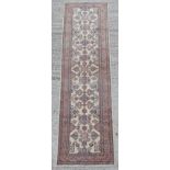 Property of a lady - a Kazak design hand knotted wool runner, with cream ground, 106 by 29ins. (