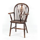 Property of a gentleman - an early 20th century elm seated Windsor wheel-back elbow chair with