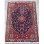 Property of a lady - a Persian Abadeh hand knotted wool rug, with red ground, 62 by 41ins. (156 by