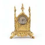 The Henry & Tricia Byrom Collection - a small gilt metal gothic cased mantel clock timepiece, the