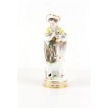 Property of a gentleman - a Meissen figure of a young man holding a messenger bird with a love