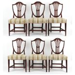 Property of a gentleman - a set of six George III carved mahogany shield-back dining chairs in the