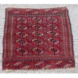 Property of a lady - an early 20th century Turkoman small rug, 41ins. (104cms.) square.