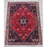 Property of a lady - a Persian Qashgai hand knotted wool rug, with navy ground, 60 by 41ins. (152 by