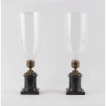 Property of a lady - a pair of bronze mounted black marble candle holders with clear glass storm