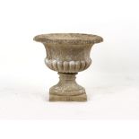 Property of a gentleman - a well weathered reconstituted stone two-part garden urn, of fluted