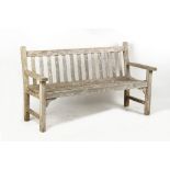 Property of a gentleman - a well weathered teak garden bench, 62.5ins. (159cms.) long.